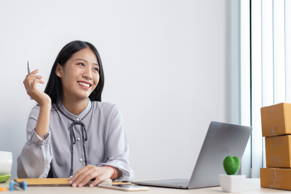 Happy Entrepreneur at Her Workstation    