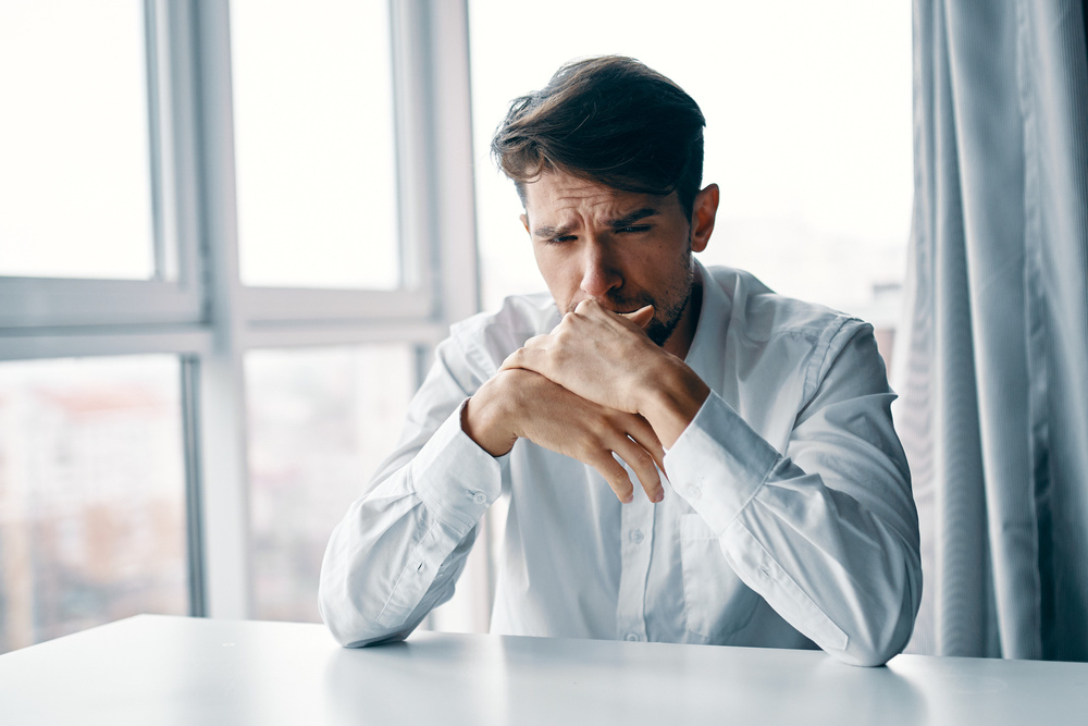 Worried Man Sitting at a Table